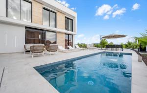 a swimming pool in the backyard of a house at Villa Lux1 Tribunj in Tribunj