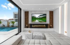 a living room with a couch and a fireplace at Villa Lux1 Tribunj in Tribunj