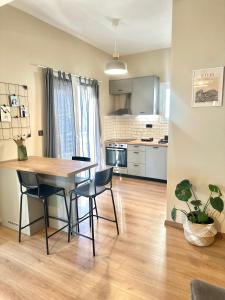 a kitchen and dining room with a table and chairs at 2 Doors- Luxury by the sea, easy parking in Kavala