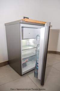 an empty refrigerator with its door open in a room at Casa e Appartamento per Vacanze JASMINE in Rome +51 photos