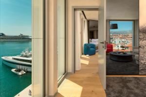 a hallway with a room with a view of the water at Hotel Ambasador in Split