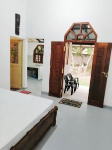 a room with two doors and a chair in it at Green Hill Villa in Unawatuna +6 photos