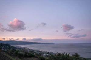 a view of the ocean from a hill at Ocean View with hot tub in Barmouth