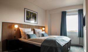 Postel nebo postele na pokoji v ubytování Hotel Phønix Hjørring