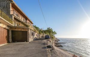 a car parked on a road next to the water at Gorgeous Apartment In Sveti Juraj in Sveti Juraj +12 photos