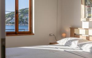 a bedroom with a bed and an open window at Gorgeous Apartment In Sveti Juraj in Sveti Juraj