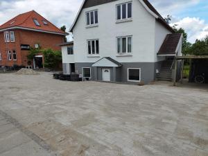 a large white house with a driveway in front of it at Fjeldgaard in Odense