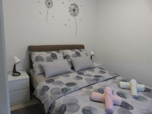 a bedroom with a bed with two slippers on it at Aurea Apartment Zagreb West in Zagreb