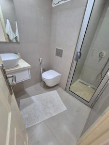 a bathroom with a shower and a toilet and a sink at My Cosy Place Rabat - Cosy Home Wifak Temara in Temara +43 photos