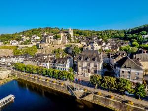 an aerial view of a town next to a river at Maison en pierre piscine clim in Varennes