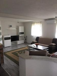 a living room with a couch and a table at Apartment In The Nature in Ilidza