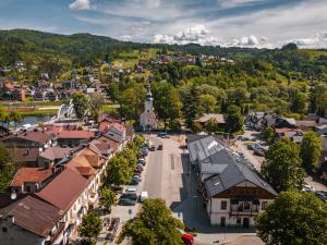 an aerial view of a town with a church at Pokoje Gościnne Malinówka in Krościenko