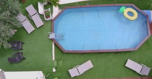 an overhead view of a swimming pool with chairs at Casetta Wetto' in Monopoli +26 photos