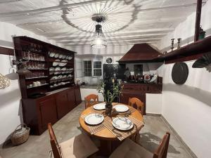 a kitchen with a table and chairs and a dining room at Villa Iren in Parakopí