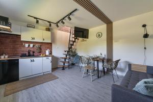 a kitchen and living room with a couch and a table at Pokoje Gościnne Malinówka in Krościenko