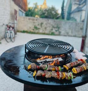 a grill with some food on top of it at HOTEL DE L'ABBAYE DE LONGPONT in Longpont