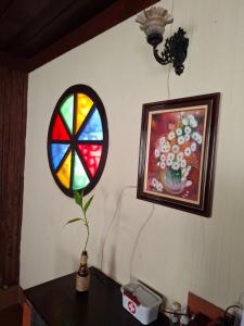 a stained glass window on a wall next to a table at Moka Refúgium-Casa de praia aconchegante e espaçosa in Belém +19 photos