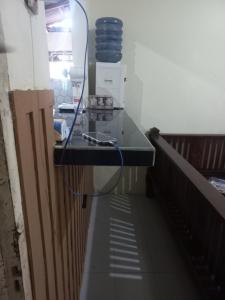 a glass counter top in a kitchen with a mirror at Esvania Homestay2 in Seturan