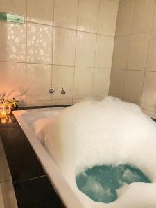 a bath tub filled with snow in a bathroom at Pousada Cardeal Mota in Serra do Cipo +92 photos