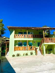 a large house with a deck and a balcony at Pousada Cardeal Mota in Serra do Cipo