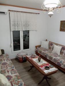 a living room with a couch and a coffee table at Irini's house in Panayia