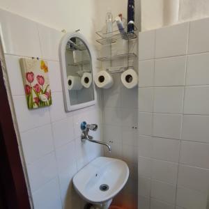 a white bathroom with a sink and a mirror at Apartmani Lovor in Herceg-Novi +19 photos