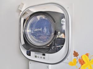 a washing machine sitting on top of a stand at Ekonomy Hotel Nampo in Busan
