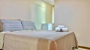 a bedroom with a bed with a teddy bear on it at Itacimirim Summer Ville - Pé na areia in Camacari +31 photos