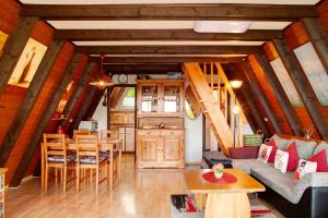 a living room with a couch and a table at Villa Königsdorf am See in Waldkirchen
