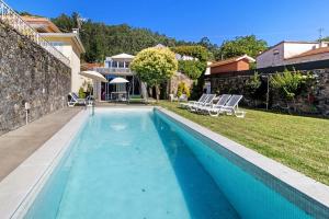 a swimming pool in the backyard of a house at Casa Da Vovó São in Vila Nova de Cerveira