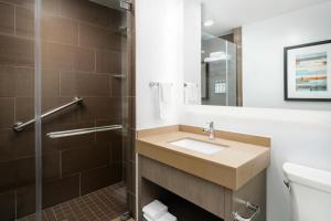 a bathroom with a sink and a shower at Hyatt House Naples 5th Avenue in Naples