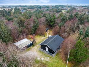 an overhead view of a small black house with a bell tower at Lovely 6-Person Cottage With Outdoor Sauna - 1007 in Ringkøbing