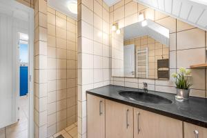a bathroom with a sink and a mirror at Vacation Home Renovated In 2023 With A 6-Person Hot Tub - 1010 in Ringkøbing +28 photos