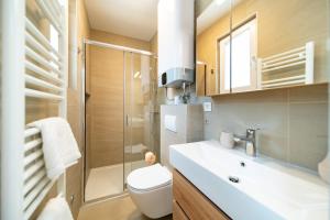 a bathroom with a toilet and a sink and a shower at Arti Holiday Homes in Banjol +28 photos