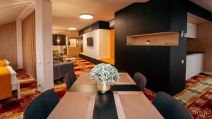 a dining room with a table and chairs at Apartmán RICHELIEU 2 in Bardejov