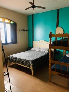 a bedroom with a bunk bed and a fan at Casa em Peruibe 3 dormitórios sendo 1 suite Pe na Areia in Peruíbe +69 photos