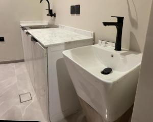 a bathroom with a sink and a faucet at Golden New Al Andalus Abha in Abha