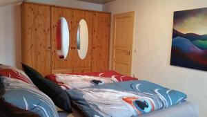 a bedroom with two beds and a wooden cabinet at Ferienwohnung Sonnenblume in Halblech