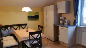 a room with a table and a kitchen with a table and chairs at Ferienwohnung Sonnenblume in Halblech +10 photos