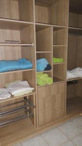 a closet with wooden shelves and some towels at LOFT Surf & Playa El Medano con WIFI Luminoso Ideal con Mascotas in El Médano