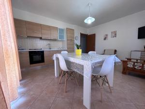 Una cocina con una mesa y sillas en una habitación. en Casa Lana, en Cabras