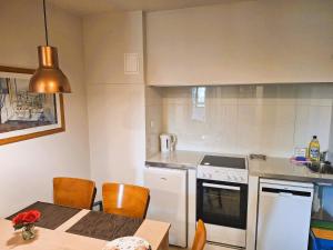 a kitchen with a table and a stove top oven at B & B Tomula in Gdańsk