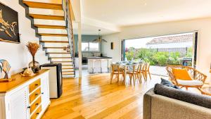 a kitchen and living room with a table and chairs at Villa des Loups de Mer in Talmont