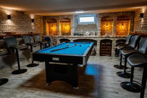 a billiard room with a pool table and chairs at Oázis Panzió in Makó