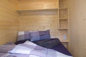 a room with a bed in a wooden cabin at Wooden Dream in Baierham