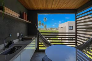 une chambre avec un hamac dans une cuisine avec vue dans l'établissement Refúgio em Condomínio Resort na Rota dos Milagres, à Porto de Pedras