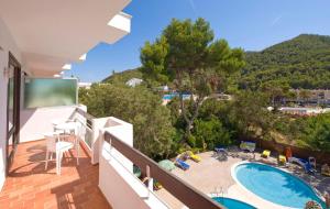 a balcony with a view of a swimming pool at Apartamentos Cala LLonga Playa in Cala Llonga