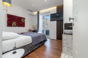 a bedroom with a bed and a bathroom with a sink at Antares Luxury Rooms 1 in Split
