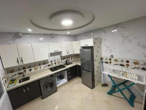 a kitchen with a refrigerator and a dishwasher at Nador New in Nador