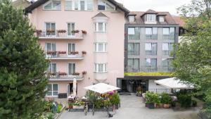 an apartment building with an umbrella in front of it at Hotel Mondschein in Vipiteno